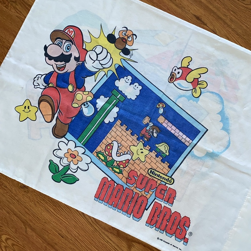 One vintage pillowcase, super Mario Brothers on one side and Zelda on the other